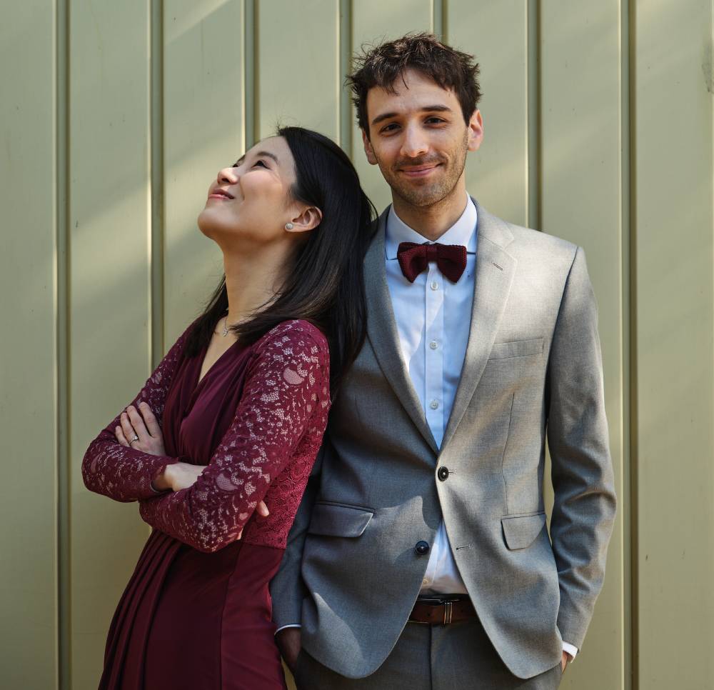 Yi-Shing and Lucas pose sheepishly in front of a wall